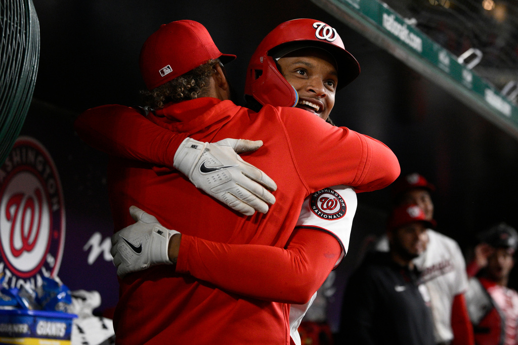Washington Nationals' CJ Abrams, front right, celebrates after his home run in the dugout during the eighth inning of a baseball game against the St. Louis Cardinals, Monday, April 6, 2026, in Washington. (AP Photo/Nick Wass)