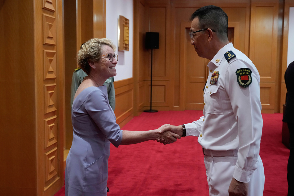 Chrissy Houlahan, D- Pennsylvania, House Armed Services Committee, left, shakes hands with Chinese Defense Minister Dong Jun at the Ministry of Defense in Beijing, China, Monday, Sept. 22, 2025. (AP Photo/Mahesh Kumar A., Pool)