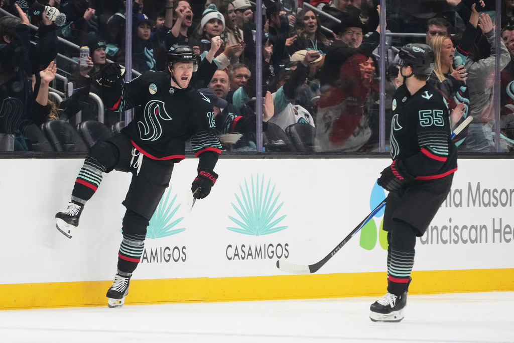 Seattle Kraken left wing Jared McCann, left, celebrates with defenseman Ryan Lindgren after his goal against the Anaheim Ducks during the second period of an NHL hockey game Friday, Jan. 23, 2026, in Seattle. (AP Photo/Lindsey Wasson)