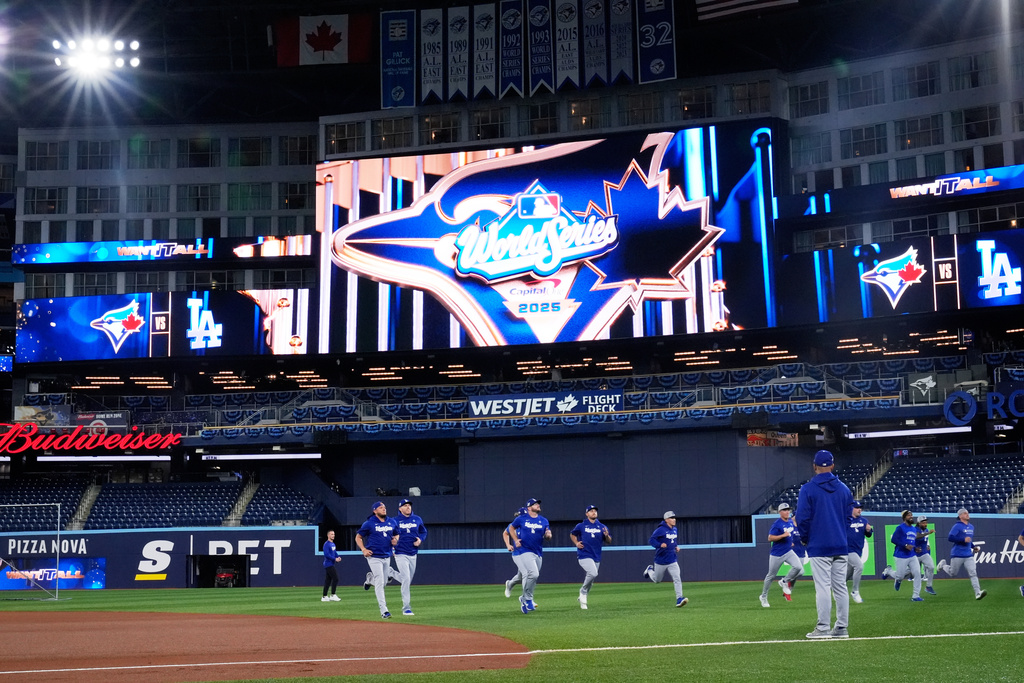 Members of the Los Angeles Dodgers warn up during a World Series baseball media day, Thursday, Oct. 23, 2025, in Toronto. The Toronto Blue Jays face the Los Angeles Dodgers in Game 1 on Friday. (AP Photo/Brynn Anderson)