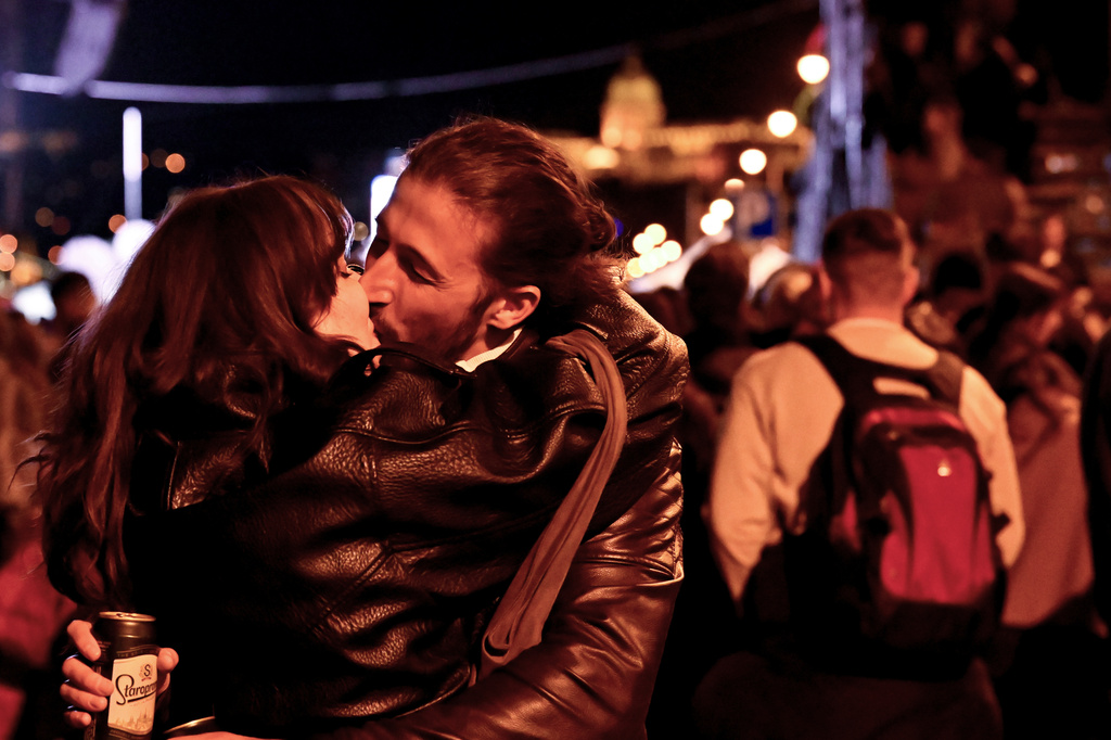 A couple kisses in the streets following the announcement of the partial results of the parliamentary election, in Budapest, Hungary, Sunday, April 12, 2026. (AP Photo/Denes Erdos)