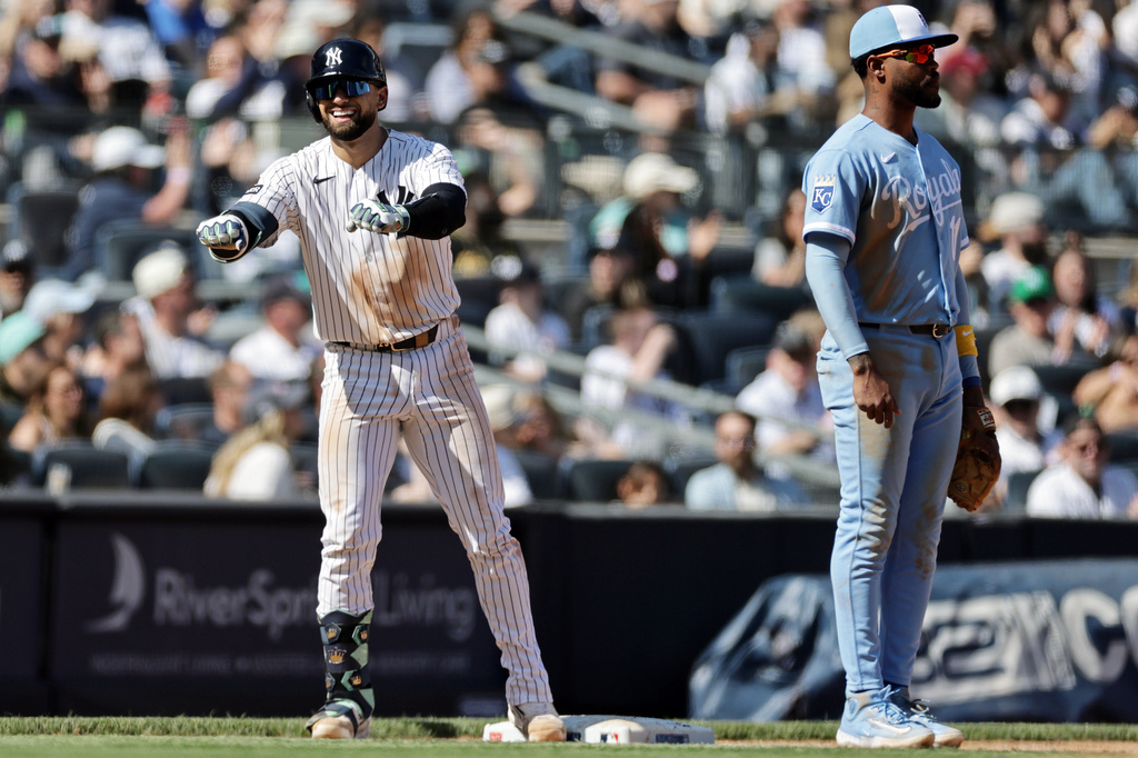 New York Yankees' J.C. Escarra reacts after hitting a two-run scoring triple next to Kansas City Royals third baseman Maikel Garcia during the seventh inning of a baseball game Saturday, April 18, 2026, in New York. (AP Photo/Adam Hunger)