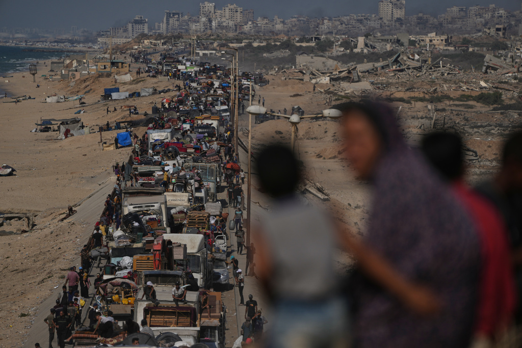 Displaced Palestinians flee northern Gaza Strip, by foot and in vehicles, carrying their belongings along the coastal road, near Wadi Gaza, Tuesday, Sept. 23, 2025. (AP Photo/Abdel Kareem Hana)