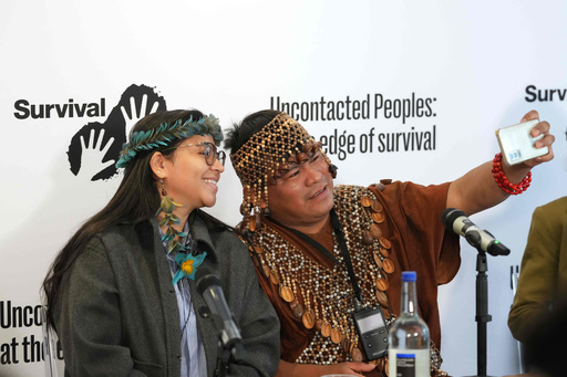 Maipatxi Apurina, left, and Herlin Odicio, right, take a photograph at the launch of Survival International's major new report on the world's uncontacted Indigenous peoples, in London, Monday, Oct. 27, 2025. (AP Photo/Kirsty Wigglesworth) Maipatxi Apurina, left, and Herlin Odicio, right, take a photograph at the launch of Survival International's major new report on the world's uncontacted Indigenous peoples, in London, Monday, Oct. 27, 2025. (AP Photo/Kirsty Wigglesworth)