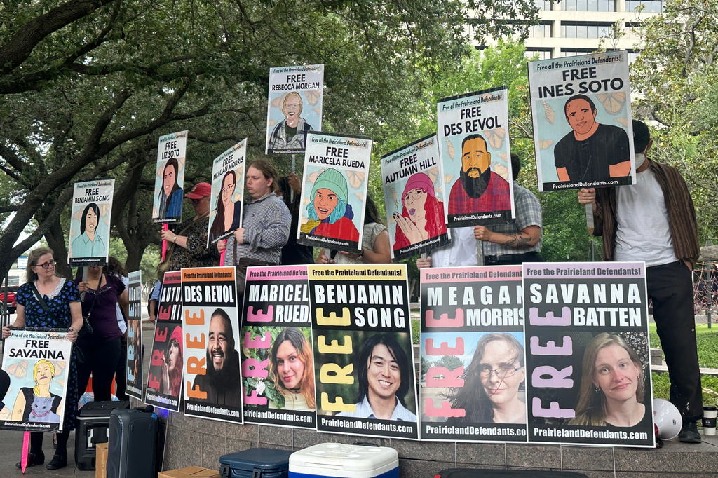 Supporters of protesters convicted over a shooting outside a Texas immigration detention center display signs in support of the defendants outside a federal courthouse in Fort Worth, Texas on Tuesday, June 23, 2026. (AP Photo/Kendria LaFleur)