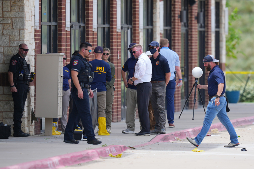 Officials respond to the scene of a shooting Tuesday, May 5, 2026, at K Towne Plaza in Carrollton, Texas. (AP Photo/Julio Cortez)