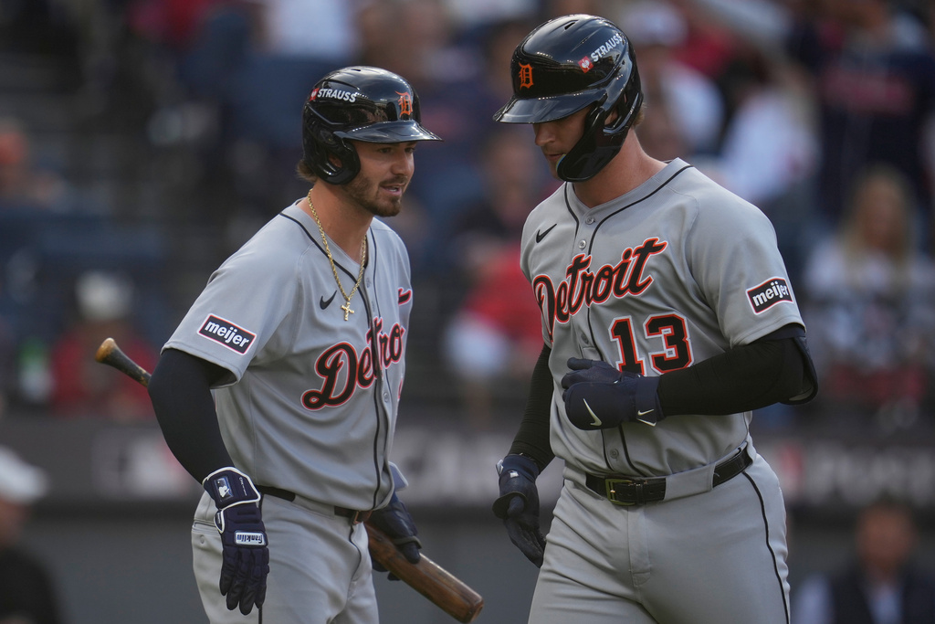 Detroit Tigers' Dillon Dingler (13) crosses home plate while acknowledged by teammate Zach McKinstry (39) after hitting a solo home run during the sixth inning of Game 3 of the American League Wild Card baseball playoff series against the Cleveland Guardians in Cleveland, Thursday, Oct. 2, 2025. (AP Photo/Sue Ogrocki)
