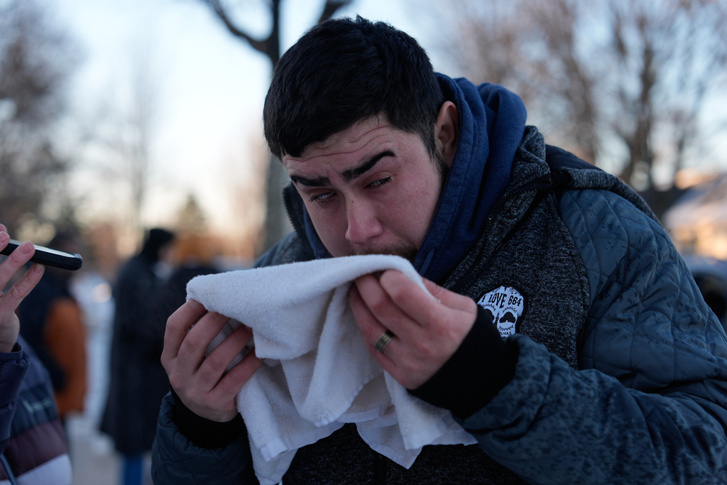 A person is attended to after federal officers used a chemical irritant on Wednesday, Jan. 28, 2026, in Minneapolis. (AP Photo/Julia Demaree Nikhinson)