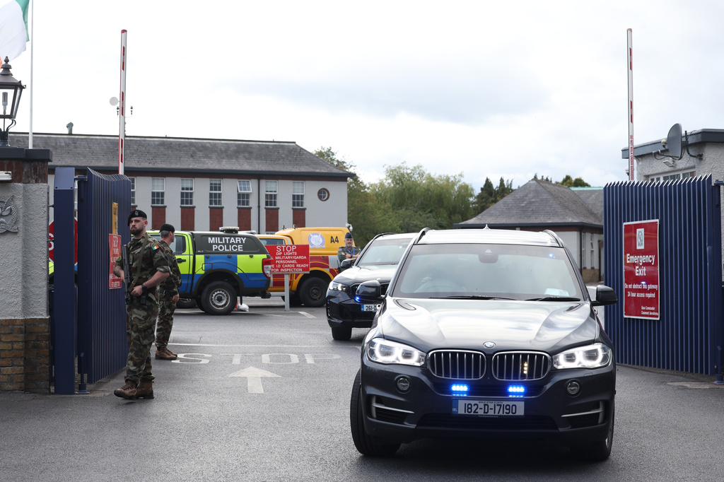 Garda vehicles leaving Casement Aerodrome, Baldonnell, Ireland, Sunday, Aug. 9, 2026, where a Irish government plane believed to be carrying Daniel Kinahan landed, following him being extradited from Dubai, to face a charge of directing an organized crime group. (Damien Eagers/PA via AP)