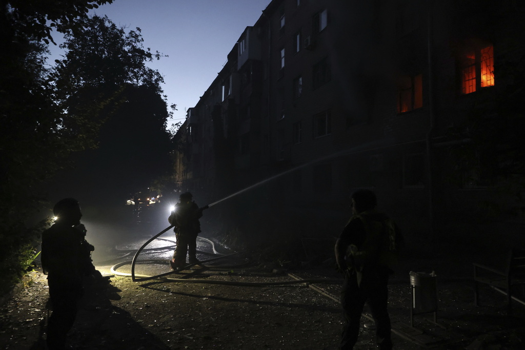 Rescue workers put out a fire at a residential building destroyed by a Russian air strike in Zaporizhzhia, Ukraine, Saturday, Aug. 30, 2025. (AP Photo/Kateryna Klochko)