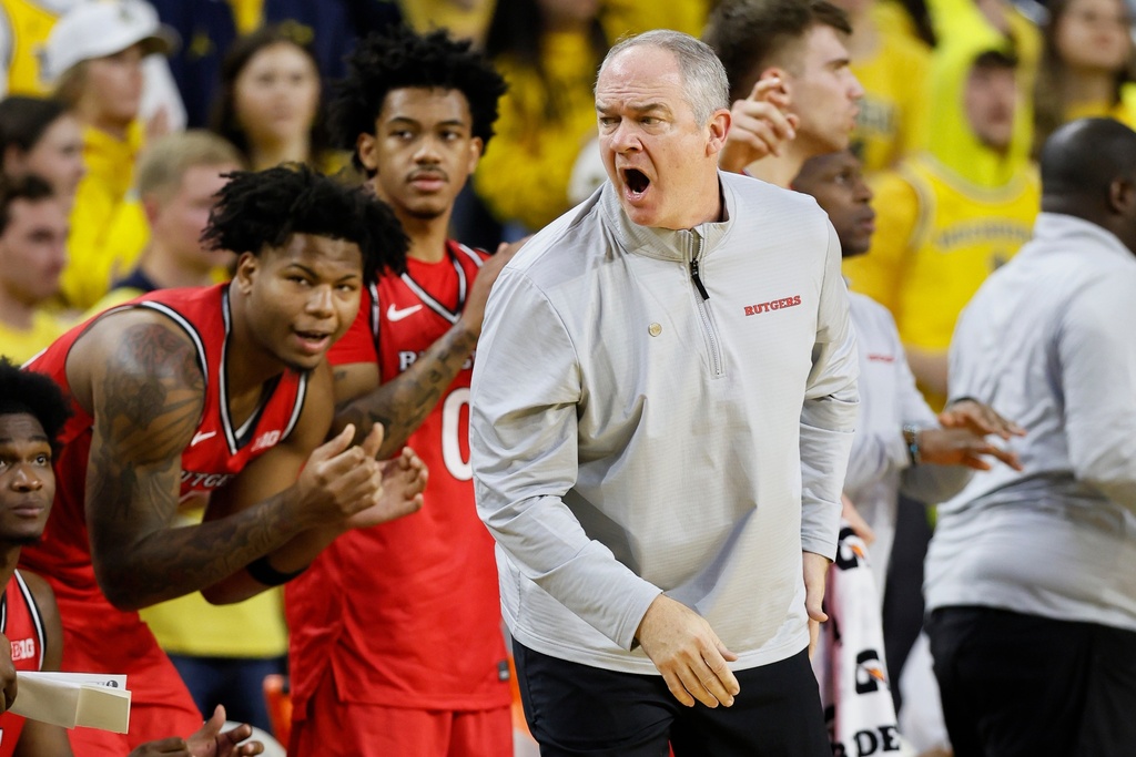 Rutgers head coach Steve Pikiell, front right, shouts at an official during the first half of an NCAA college basketball game against Michigan, Saturday, Dec. 6, 2025, in Ann Arbor, Mich. (AP Photo/Duane Burleson)