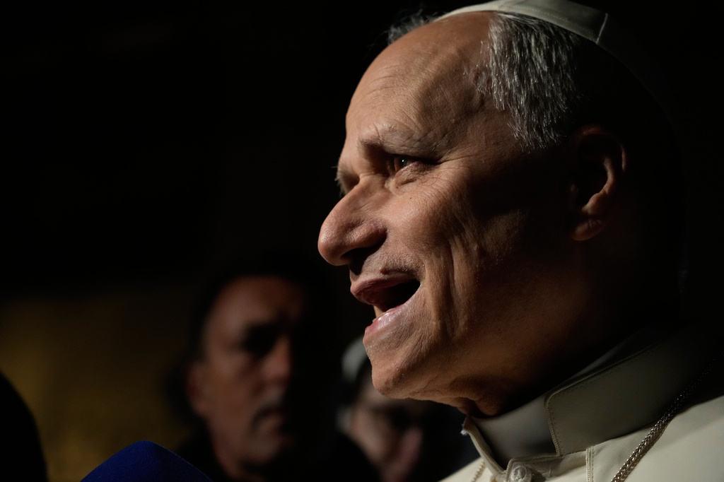 Pope Leo XIV talks to journalists as he leaves his residence in Castel Gandolfo, on the outskirts of Rome, to return to the Vatican, Tuesday, March 31, 2026. (AP Photo/Gregorio Borgia)