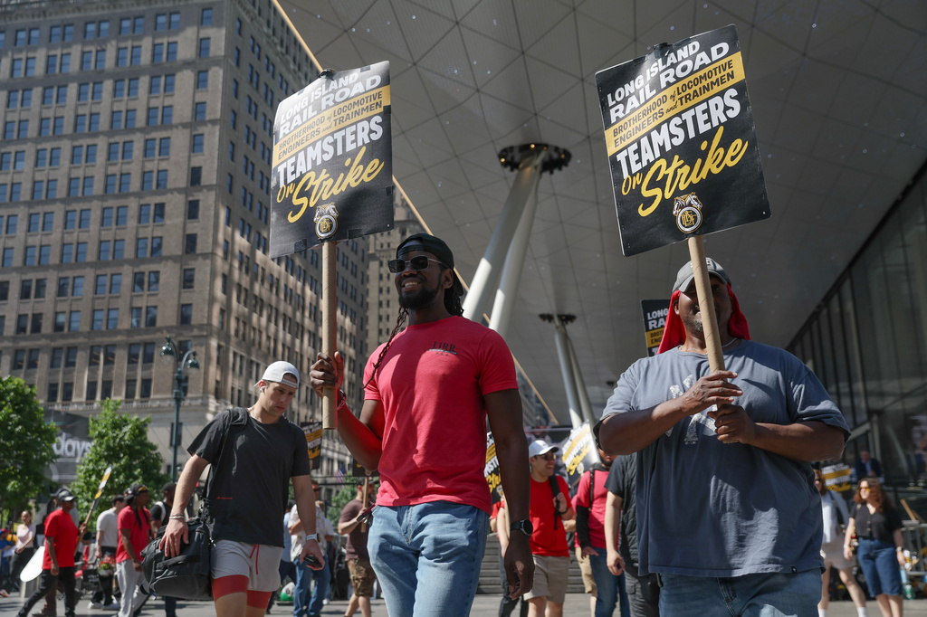 Long Island Rail Road workers walk on the picket line outside of Penn Station on the third day of their strike, Monday, May 18, 2026, in New York. (AP Photo/Heather Khalifa)