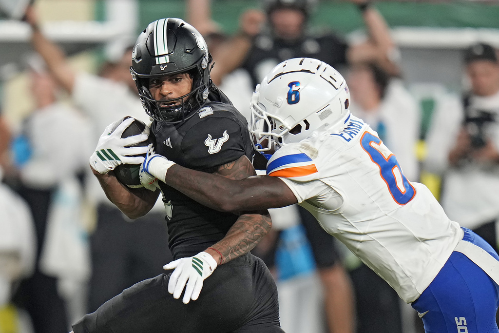 South Florida wide receiver Chas Nimrod (2) is stopped by Boise State defensive back Jeremiah Earby (6) after a catch during the second half of an NCAA college football game Thursday, Aug. 28, 2025, in Tampa, Fla. (AP Photo/Chris O'Meara)