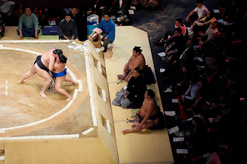 Ryuden battles with Fujinokawa in the Makuuchi Division bout on day three of the Grand Sumo Tournament at the Royal Albert Hall, London, Friday, Oct. 17, 2025. (Jordan Pettitt/PA via AP)
