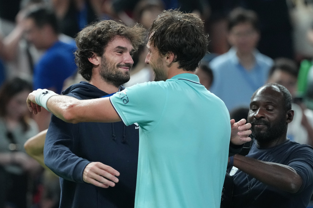 Arthur Rinderknech of France, right, is greeted by his cousin Valentin Vacherot of Monaco after defeating Daniil Medvedev of Russia in the men's singles semifinal match of the Shanghai Masters tennis tournament at Qizhong Forest Sports City Tennis Center, in Shanghai, China, Saturday, Oct. 11, 2025. (AP Photo/Andy Wong)