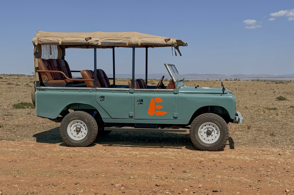 In this photo taken with a smartphone, an electric safari van operated by Emboo Camp is parked in the Maasai Mara, Kenya, Saturday, Aug. 29, 2026. (AP Photo/Allan Olingo)