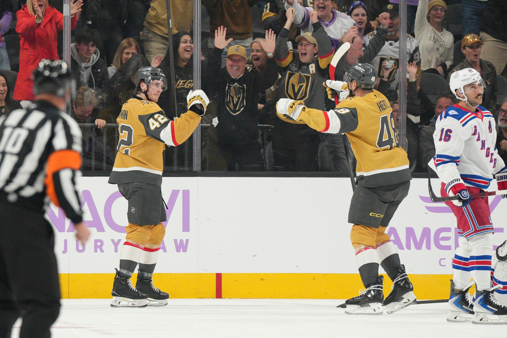 Vegas Golden Knights right wing Braeden Bowman (42) celebrates his goal with center Tomas Hertl (48) against the New York Rangers during the first period of an NHL hockey game Tuesday, Nov. 18, 2025, in Las Vegas. (AP Photo/Candice Ward)
