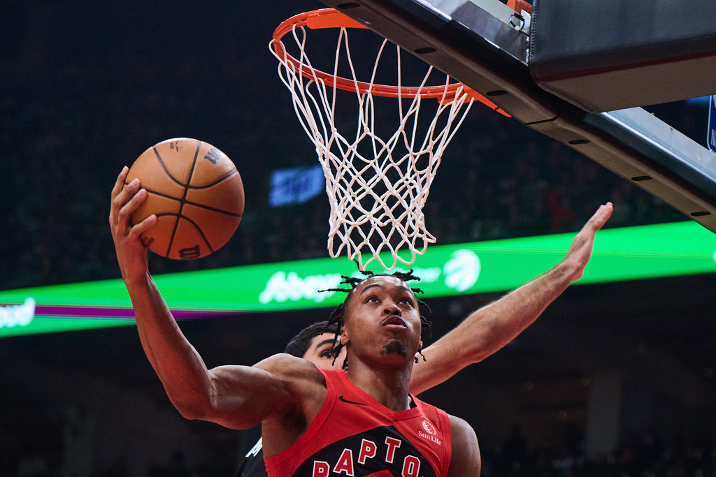 Toronto Raptors' Scottie Barnes, front, drives to the net past Memphis Grizzlies' Santi Aldama, back, during first-half NBA basketball game action in Toronto, Sunday, Nov. 2, 2025. (Sammy Kogan/The Canadian Press via AP)