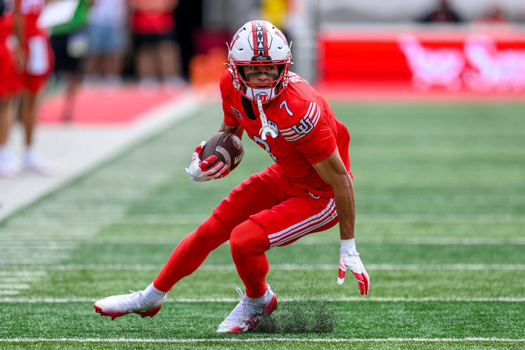 Utah wide receiver Braden Pegan runs the ball for a touchdown after a catch during the first half of an NCAA college football game against Utah State, Saturday, Sept. 19, 2026, in Salt Lake City. (AP Photo/Tyler Tate)