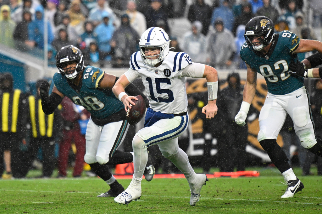 Indianapolis Colts quarterback Riley Leonard (15) heads to the end zone for a touchdown against the Jacksonville Jaguars during the second half of an NFL football game, Sunday, Dec. 7, 2025, in Jacksonville, Fla. (AP Photo/Phelan M. Ebenhack)