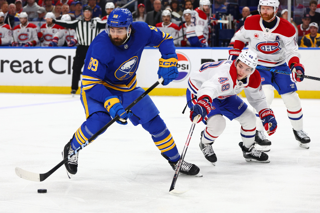 Buffalo Sabres right wing Alex Tuch (89) is pressured by Montreal Canadiens defenseman Lane Hutson (48) during the first period in Game 7 of a second-round NHL hockey Stanley Cup playoff series Monday, May 18, 2026, in Buffalo, N.Y. (AP Photo/Jeffrey T. Barnes)