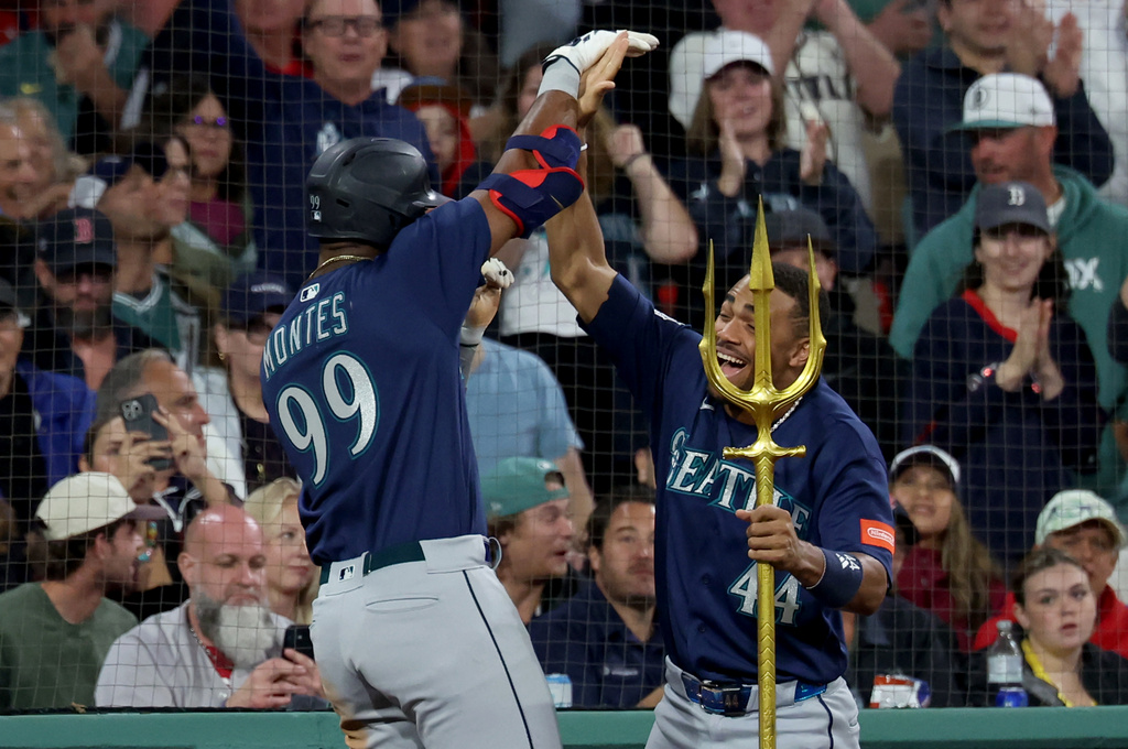 Seattle Mariners designated hitter Lazaro Montes (99) and outfielder Julio Rodríguez (44) celebrate Montes' home run during the fifth inning of a baseball game against the Boston Red Sox, Tuesday, Sept. 1, 2026, in Boston. (AP Photo/Mark Stockwell)