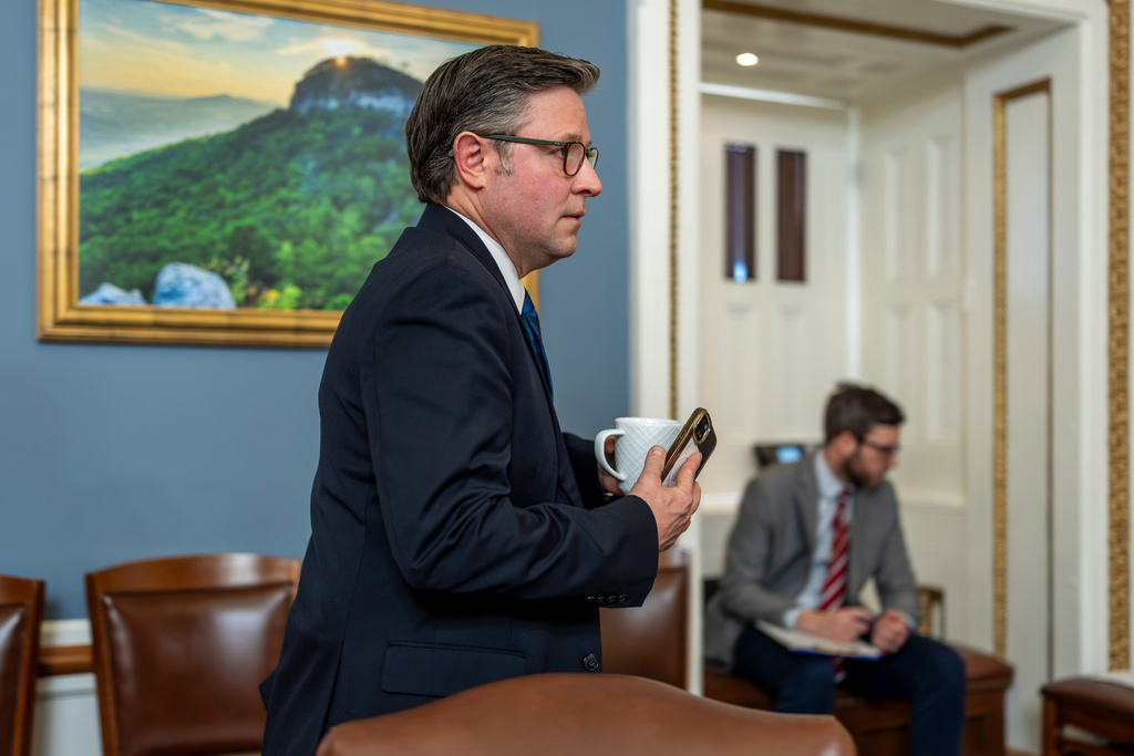 Speaker of the House Mike Johnson, R-La., walks through the House Rules Committee hearing room to meet with Republicans on the panel as they try to advance a federal funding package and prevent a prolonged partial government shutdown, at the Capitol in Washington, Monday, Feb. 2, 2026. (AP Photo/J. Scott Applewhite)
