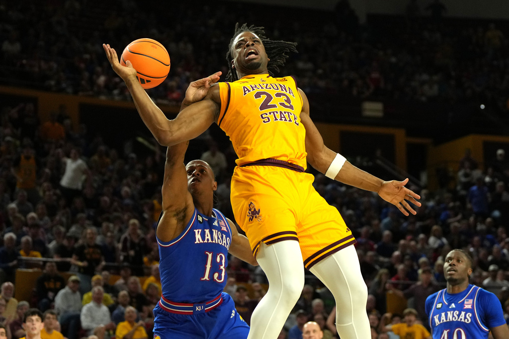 Kansas guard Elmarko Jackson (13) fouls Arizona State forward Allen Mukeba (23) during the second half of an NCAA college basketball game, Tuesday, March 3, 2026, in Tempe, Ariz. (AP Photo/Rick Scuteri)