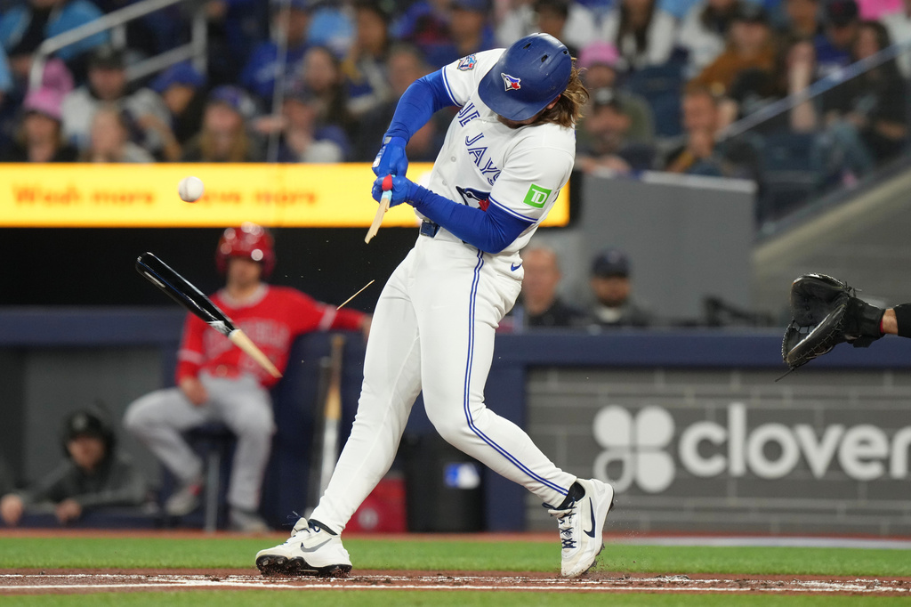 Toronto Blue Jays' Addison Barger breaks his bat while facing Los Angeles Angels pitcher Jack Kochanowicz during first-inning baseball game action in Toronto, Saturday, May 9, 2026. (Chris Young/The Canadian Press via AP)