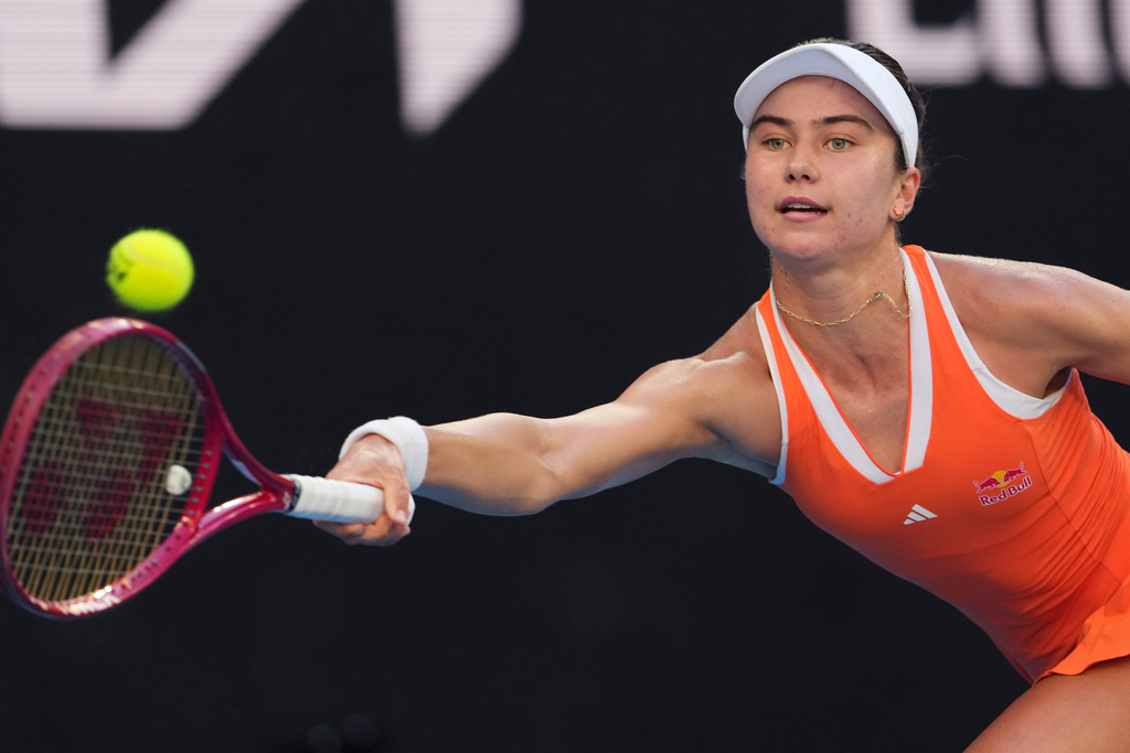 Iva Jovic of the U.S. plays a forehand return to Jasmine Paolini of Italy during their third round match at the Australian Open tennis championship in Melbourne, Australia, Friday, Jan. 23, 2026. (AP Photo/Aaron Favila)