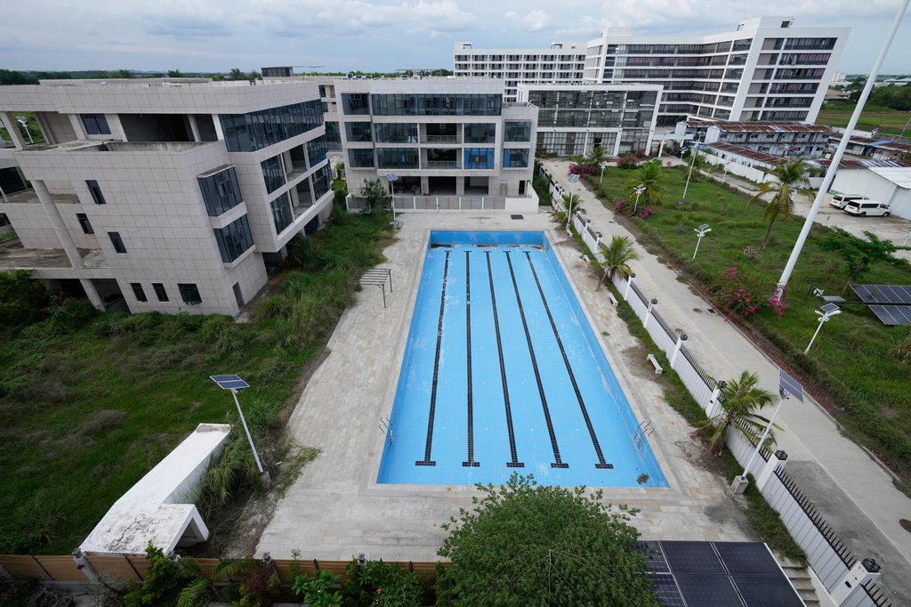 A swimming pool sits empty at the sprawling former Baofu scam compound that was raided by authorities last year in Bamban, Tarlac city, northern Philippines, Thursday, June 5, 2025. (AP Photo/Aaron Favila)