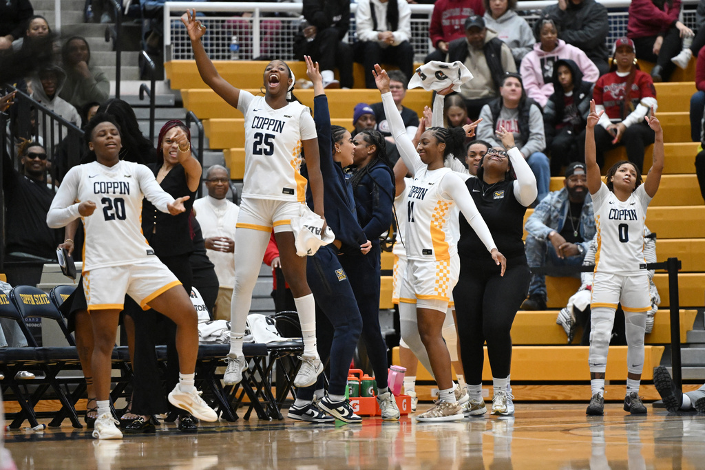 Members of the Coppin State team cheer as their team scores against South Carolina during the second half of an NCAA college basketball game Sunday, Jan. 18, 2026, in Baltimore. (AP Photo/Gail Burton)