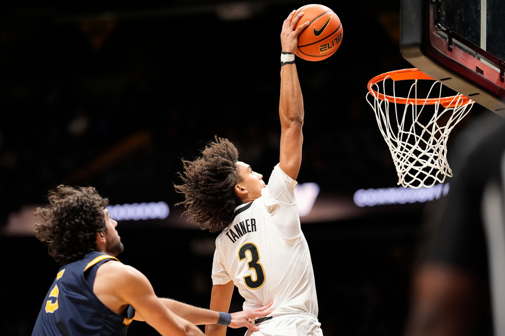 Vanderbilt guard Tyler Tanner (3) dunks the ball past New Haven forward Stefano Faloppa (5) during the first half of an NCAA college basketball game Monday, Dec. 29, 2025, in Nashville, Tenn. (AP Photo/George Walker IV)