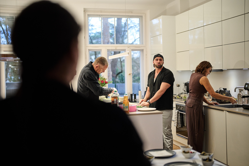 Gay Muslim influencer Ali Darwich, center, hosts an inclusive Iftar, the Ramadan fast-breaking meal, with friends who are Muslim, Christian, queer and straight, in Berlin, Germany, Wednesday, March 11, 2026. (AP Photo/Ebrahim Noroozi)