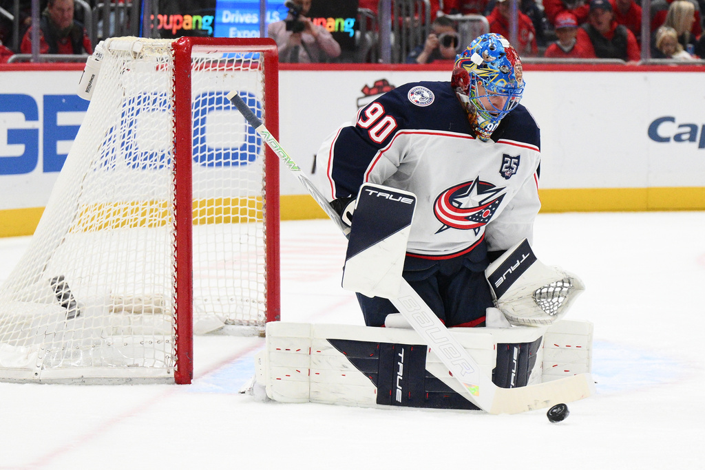 Columbus Blue Jackets goaltender Elvis Merzlikins (90) stops the puck during the first period of an NHL hockey game against the Washington Capitals, Monday, Nov. 24, 2025, in Washington. (AP Photo/Nick Wass)