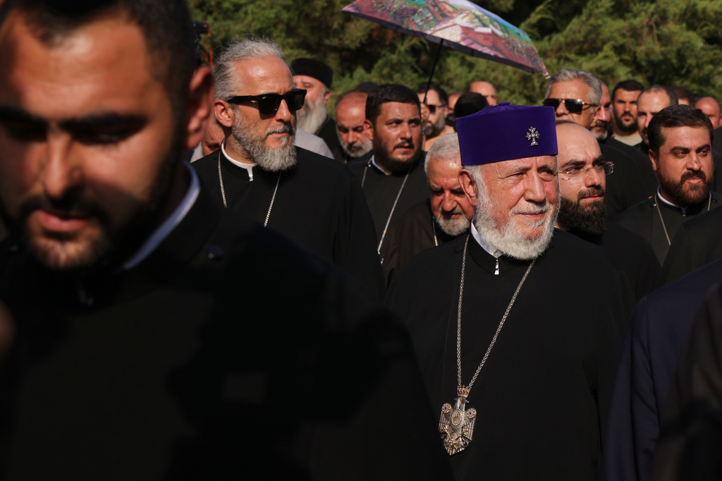 The head of the Armenian Apostolic Church Catholicos Karekin II, right, leaves the Armavir Court of First Instance in Vagharshapat, Armenia, Friday, Aug. 7, 2026. (AP Photo/Anthony Pizzoferrato)
