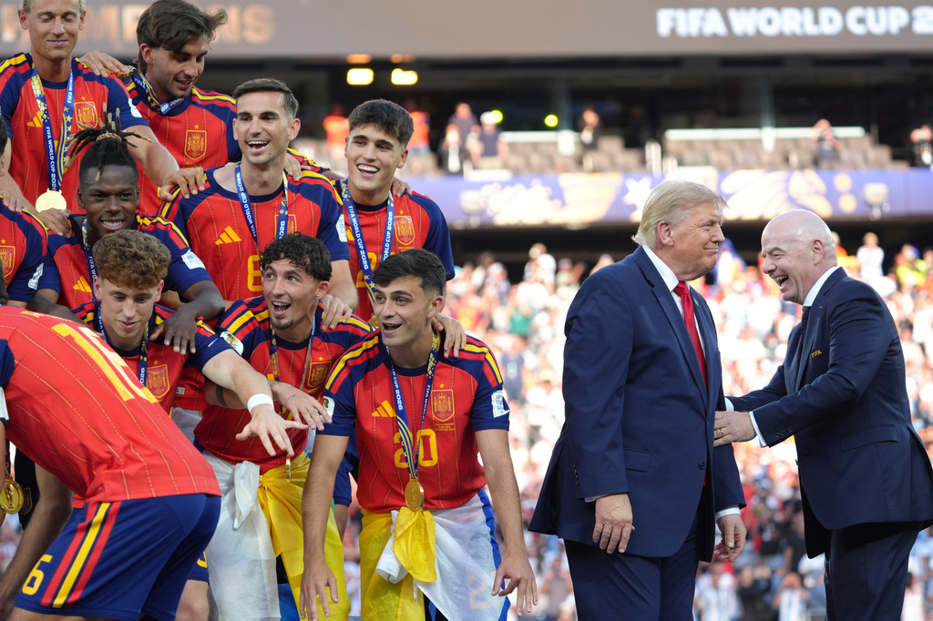 Spain players, from left, cheer alongside President Donald Trump and FIFA President Gianni Infantino at the conclusion of the World Cup championship final soccer match between Spain and Argentina in East Rutherford, N.J., Sunday, July 19, 2026. (AP Photo/Jacquelyn Martin)