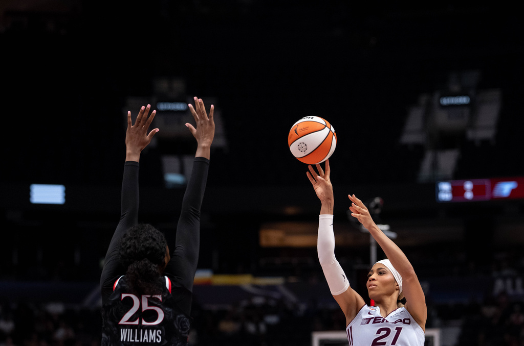 Toronto Tempo's Isabelle Harrison (21) shoots as Portland Fire's Serah Williams (25) defends during the first half of a WNBA basketball game in Vancouver, British Columbia, Friday, Aug. 21, 2026. (Ethan Cairns/The Canadian Press via AP)