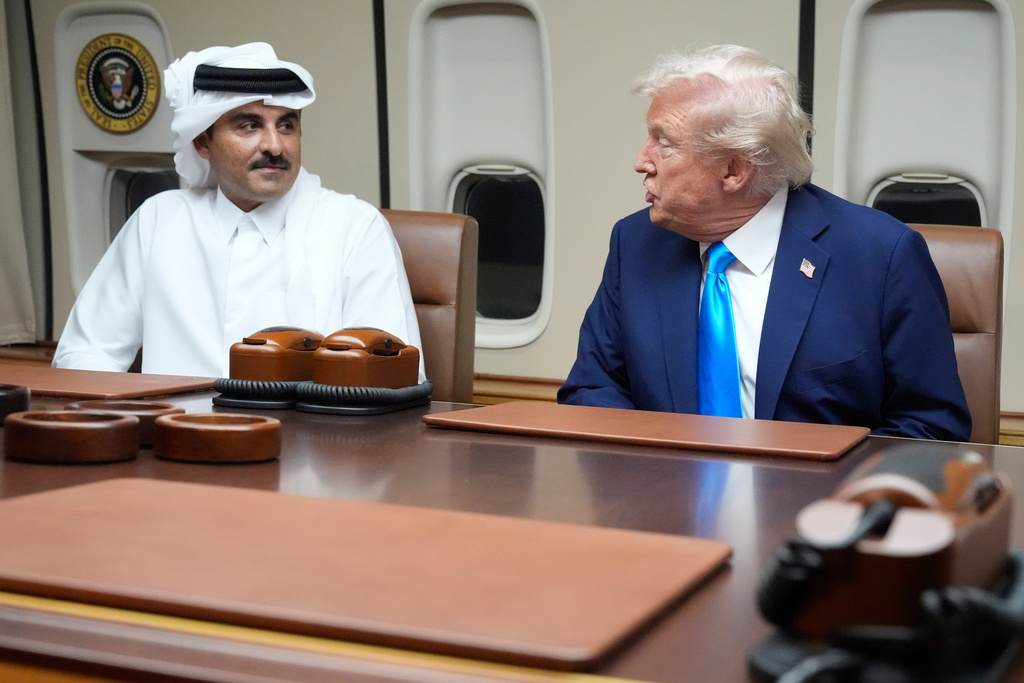 FILE - President Donald Trump, right, meets with Emir of Qatar Sheikh Tamim bin Hamad al-Thani aboard Air Force One at Al Udeid Air Base in Doha, Qatar, Saturday, Oct. 25, 2025. (AP Photo/Mark Schiefelbein, File)