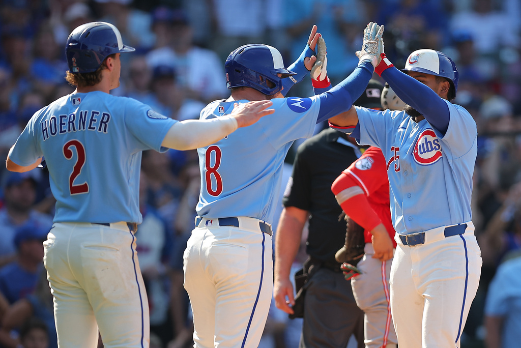 Chicago Cubs' Pedro Ramírez, left, celebrates with teammates Ian Happ, middle, and Nico Hoerner, left after hitting a three-run home run during the eighth inning of a baseball game against the Cincinnati Reds, Friday, Aug. 28, 2026, in Chicago. (AP Photo/Melissa Tamez)