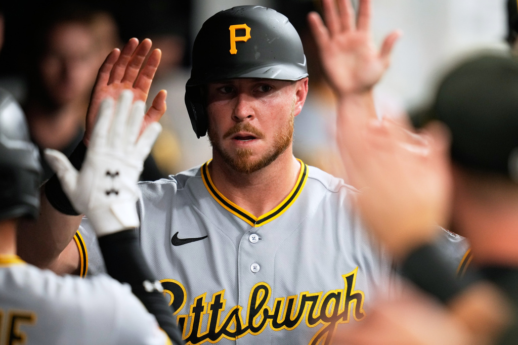 Pittsburgh Pirates' Ryan O'Hearn is congratulated in the dugout after scoring in the second inning of the second baseball game of a split doubleheader against the Cleveland Guardians in Cleveland, Saturday, June 18, 2026. (AP Photo/Sue Ogrocki)