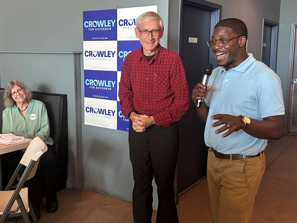 Wisconsin Gov. Tony Evers, center, campaigns with Democratic candidate for Governor David Crowley, right, Monday, Aug. 10, 2026, in Madison, Wis. (AP Photo/Scott Bauer)