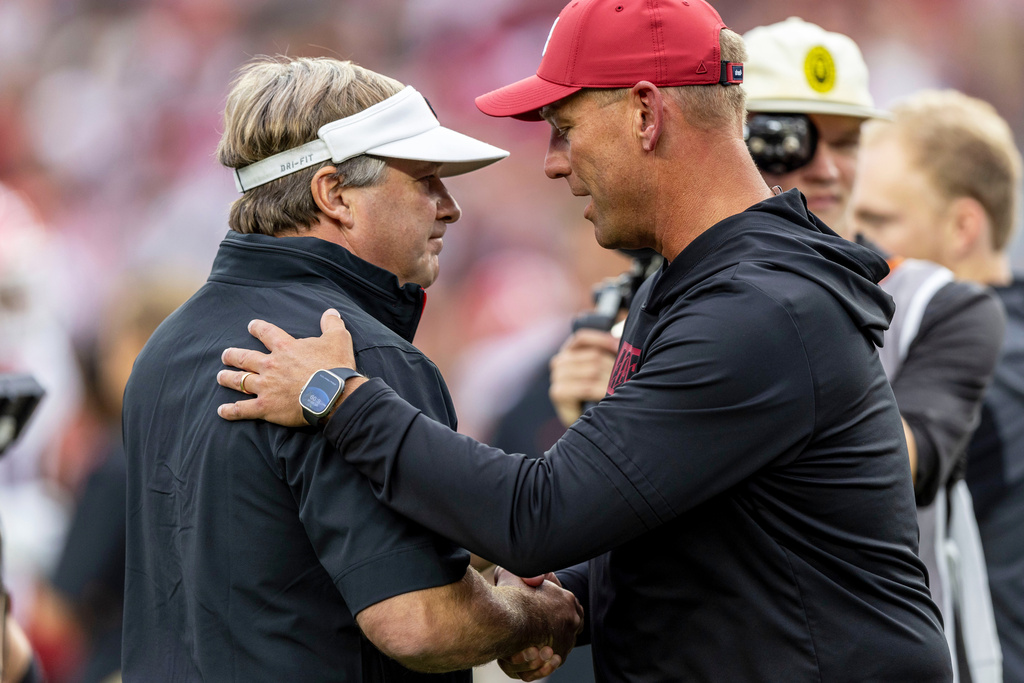 FILE - Georgia head coach Kirby Smart, left, and Alabama head coach Kalen DeBoer meet at midfield before an NCAA college football game, Sept. 28, 2024, in Tuscaloosa, Ala. (AP Photo/Vasha Hunt, File)