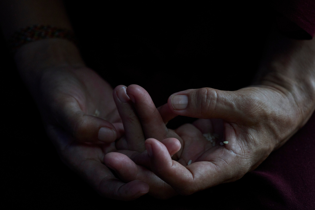 A Tibetan woman offers prayers during the 91st birthday celebration of spiritual leader the Dalai Lama in Kathmandu, Nepal, Monday, July 6, 2026. (AP Photo/Niranjan Shrestha)