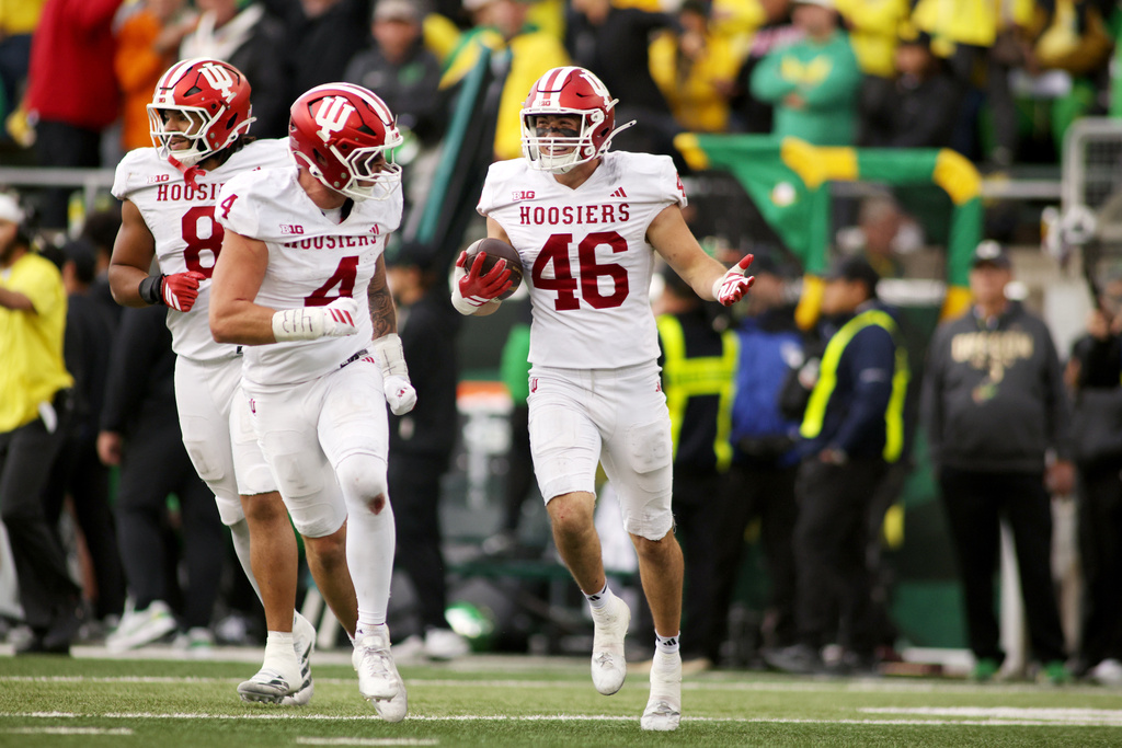 Indiana linebacker Isaiah Jones (46) celebrates after an interception with linebacker Aiden Fisher (4) during the second half of an NCAA college football game against Oregon, Saturday, Oct. 11, 2025, in Eugene, Ore. (AP Photo/Lydia Ely)