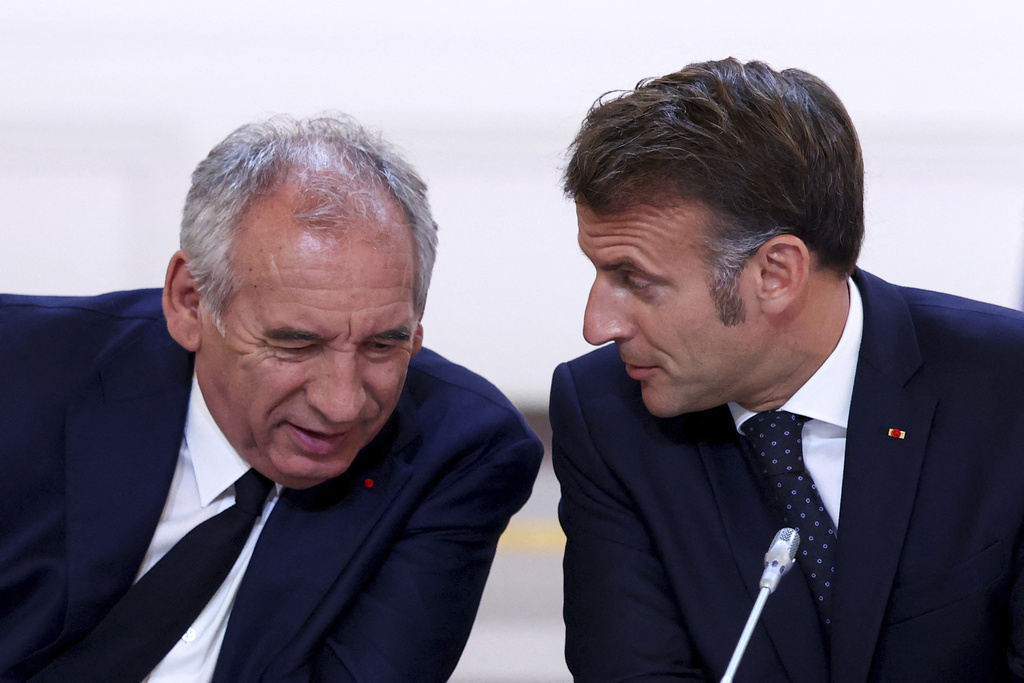 FILE -French President Emmanuel Macron, left, and Prime Minister Francois Bayrou attend a meeting with New Caledonia's elected officials and state representatives who have concluded a historic agreement allowing the creation of a "State of New Caledonia" within the French Republic, at the Elysee Palace in Paris, July 12, 2025. (Tom Nicholson, Pool Photo via AP, File)