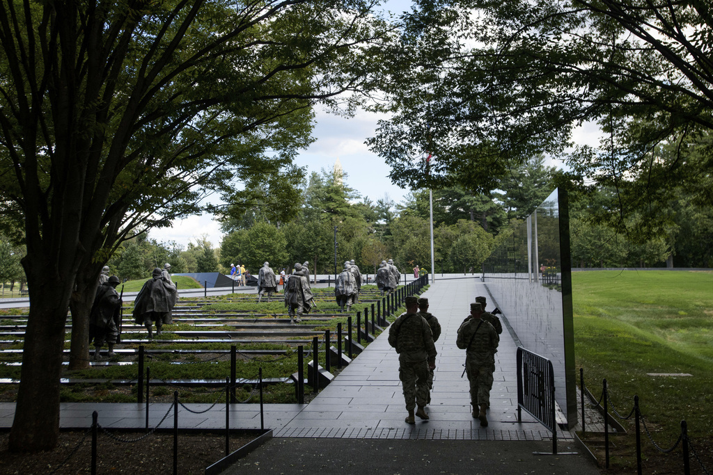 Armed members of the West Virginia National Guard patrol the Korean War Veterans Memorial in Washington, Tuesday, Aug. 26, 2025. (AP Photo/Rod Lamkey, Jr.)