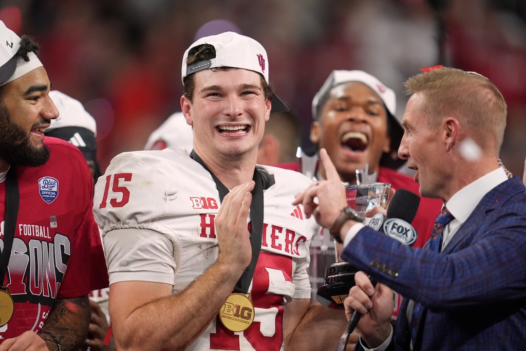 Indiana's Fernando Mendoza celebrates after after the Big Ten championship NCAA college football game against Ohio State in Indianapolis, Saturday, Dec. 6, 2025. (AP Photo/Michael Conroy)