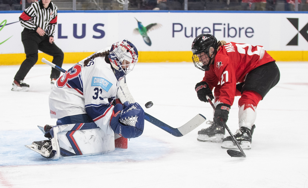 United States goaltender Gwyneth Philips (33) stops Canada's Emma Maltais (27) during third period Rivalry Series action in Edmonton on Wednesday, Dec. 10, 2025. (Jason Franson/The Canadian Press via AP)